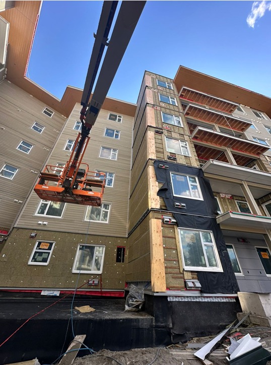 Boom lift working on building exterior